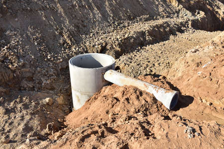 Laying concrete manholes and drain pipes for stormwater system. Connecting a trench drain to a...