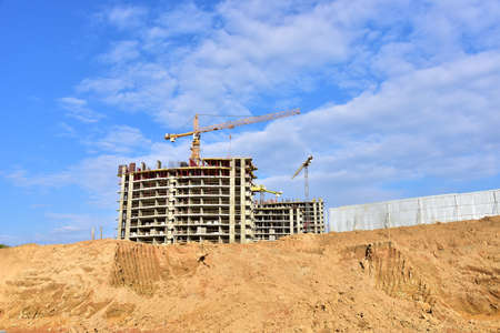 Preparing to pour a bucket of concrete into formwork.Tower crane lifting cement bucket during...