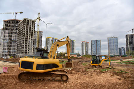 Excavator and mini excavator during excavation and road construction works at construction site....