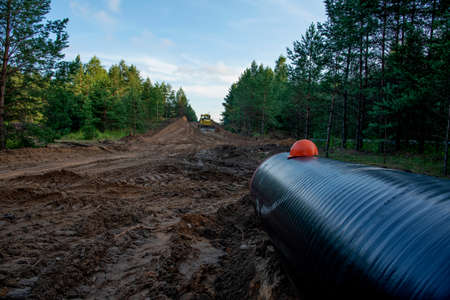 Pipeline construction project for global exports of natural gas. Building of transit petrochemical pipe in forest areaの写真素材