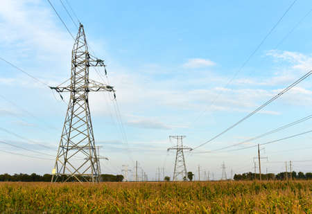 High voltage power lines on blue sky background. Electric transmission pylon tower. Wire electrical...
