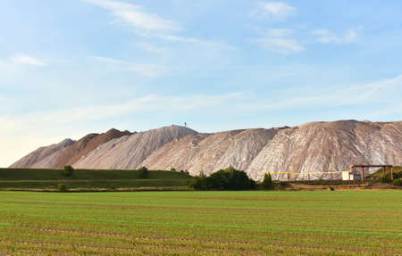 Summer landscape on the salt mountains against the blue sky. Mining industry. Extraction of silica...