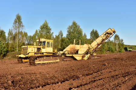 Root harvester for clear surface vegetation and cut through trees and stumps in the bog. Machinery...