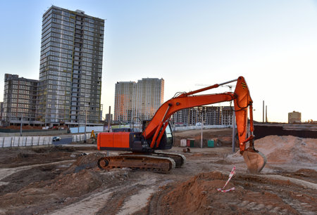 Excavator during excavation at construction site. Backhoe on road work. Heavy Construction Equipment...