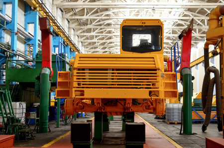 Production process of heavy mining trucks at the factory. Dump truck on the Industrial conveyor in the workshop of an automobile plant. Manufacturer of haulage and earthmoving equipment, haul trucksのeditorial素材