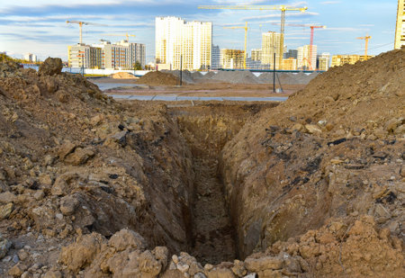 Trench for laying sewer pipes of the external sewage system at a construction site. Sanitary drainage system for a multi-story building. Civil infrastructure pipe, water lines and storm sewersの写真素材