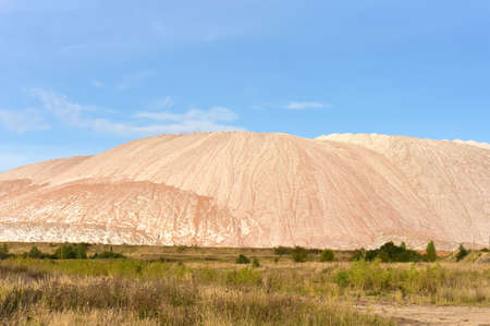 Summer landscape on the salt mountains against the blue sky. Mining industry. Extraction of silica from the ground near the city of Soligorsk in Belarus.の写真素材