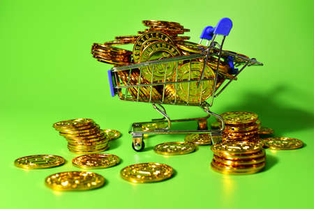 Shopping cart with bitcoin gold crypto coins. BTC cryptocurrency investing concept in mini shopping trolley. Blockchain and financial technology. Make a lot of money, be rich and spend dollarsの写真素材