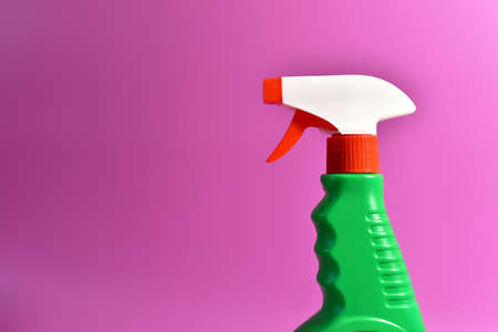 Detergent spray cleaner on purple background. Detergents for washing windows and cleaning dishes. Concentrated and anti-bacterial liquids for remove carbon, grease and dirtの写真素材