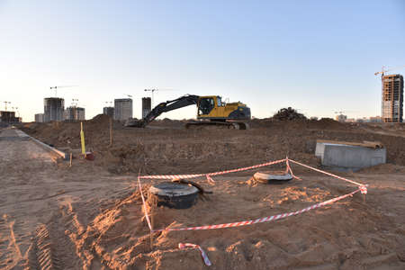 Excavator on earthworks at construction site. Backhoe on foundation work and road construction....