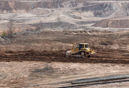 Dozer has been recovering the landscape around the open pit. Process of restoring land. Bulldozer at...