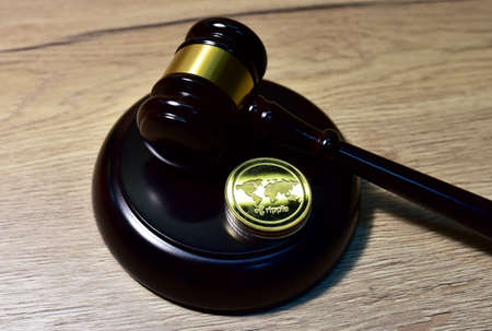 Judge hammer and XRP crypto coin. Justice courtroom. Ripple demands Bitcoin and Ethereum docs from SEC amid legal fight. Delist Ñryptocurrency trading. Exchanges and traders. law to ban blockchainの写真素材