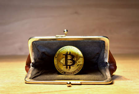Bitcoin coin in wallet for carrying money and coins. Ð¡ryptocurrency trading exchange. BTC mining and investing concept. Blockchain and financial technology. Crypto prices and market capitalizationの写真素材