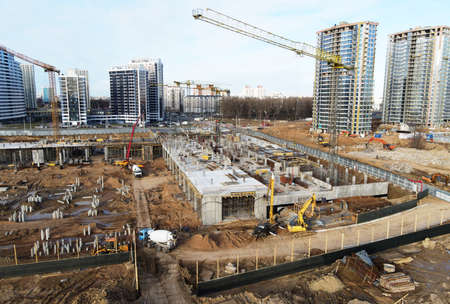 Drone view of a large construction site. Tower cranes in action. Housing renovation concept. Crane...