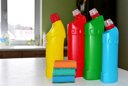 Detergent bottles and and sponge at kitchen in home. Detergents bottles and kitchen sponges....