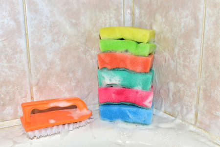 Sponge with washing brus and detergent during cleaning bathroom or toilet. Washing dishes and...