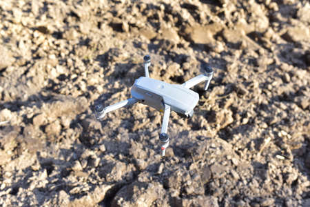 Drone flying in the air over an agricultural field. Quadcopter with HD video and a 48MP Camera 4K...