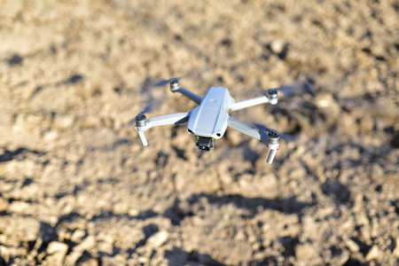 Drone flying in the air over an agricultural field. Quadcopter with HD video and a 48MP Camera 4K Video during flight. Copter for photography and 8K video recording. Unmanned aerial vehicle (UAV)の写真素材