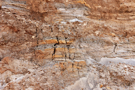 Land structure in open pit mining. Ground background in quarry. Rock texture during earthworks. Sand...