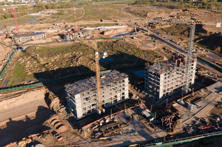 Tower cranes in action at construction site. Crane during formworks. Ð¡onstruction site with...
