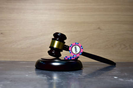 Judge hammer and poker chip for casino game. Justice courtroom. Concept of a court decision in a...