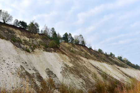 Chalk structure on artificial mountain after quarry mining. Technogenic rock formed during mine....