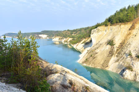 Artificial lake in a chalk quarry in Belarus at Krasnoselsky. Turquoise background of the clear...
