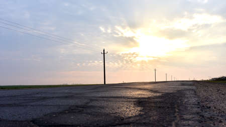 View of the road against the background of the rising sun in the spring season. Empty highway in the morningの写真素材