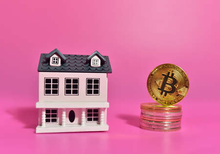 Bitcoin coin on the background of a wooden house. The concept of buying real estate and housing for cryptocurrency. BTC Crypto mining and investing. Blockchain and financial technology. Market capitalの写真素材