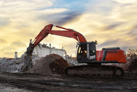 Excavator with attachment for demolishing and recycling concrete material. Crushers tool and...
