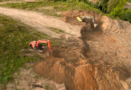 Excavator dig ground at a construction site. Trench for laying external sewer pipes. Sewage drainage...