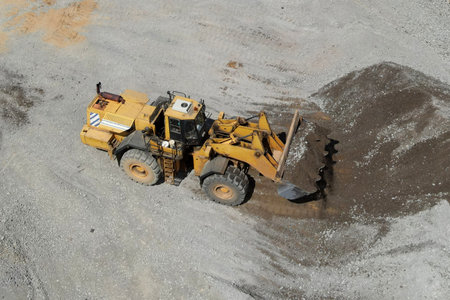 Wheel loader works in a gravel pit. Loading or unloading stone and granite from an open pit. Soft...