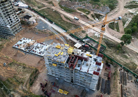 Crane during formworks on construction site. Pouring concrete into formwork. Construction the...