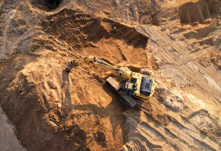 Excavator dig trench in ground at construction site. Foundation pit for a building. Earth-moving...