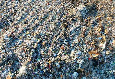 Garbage dump with plastic bags and food waste. Recycling of waste on junk yard. Dispose the rubbish...