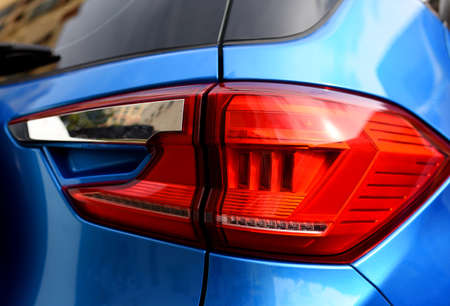 Rear LED headlamp of a modern car. Brake taillight. Red stop lighting of highway vehicles. Cars...