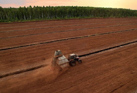 Peat Harvester Tractor on Collecting Extracting Peat. Mining and harvesting peatland. Area drained...
