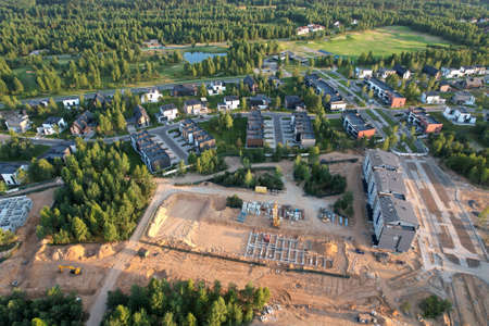 Building a country house in forest area. Unfinished private home of ceramsite concrete blocks on a...
