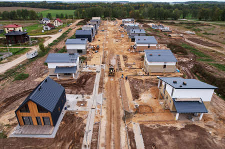 Home construction of ceramsite blocks. Construction site of the building a country houses. Suburb house construction concept. Construction work of laying bricks, gas silicate blocks and roof.の写真素材