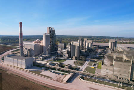 Cement plant with pipes. Cement production process and Industrial solution. factory with smoke pipe. Chimney smokestack emission. Poor environment. Ecology concept, air and environmental pollution.の写真素材