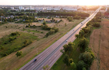 Car and truck driving on the highway. Trucks and cars in a traffic jam on rod. Cars and rush hours. Aerial view, top down of freeway traffic with truck semi trailer. Lorry driver delivers the cargo.の写真素材