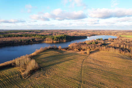 Lake on sunset in autumn season. Aerial panoramic landscape view of the lake in the wild. Drone view...