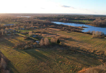 Wooden home in village at lake. Country houses in the countryside. Suburban house at countryside...