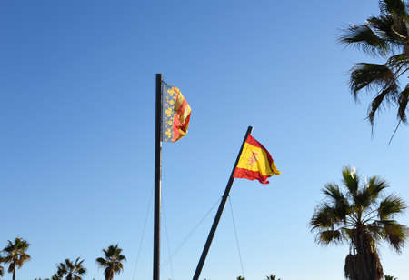 Valencian Community flag is an autonomous community of Spain. Spain flag on blue sky background.の写真素材