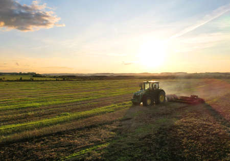 Plowing field. John Deere Tractor with disc cultivator Vaderstad on cultivating field. Agricultural tractor on cultivation field. Soil Tillage and sowing seeds. Russia, Smolensk, September 07, 2021.のeditorial素材