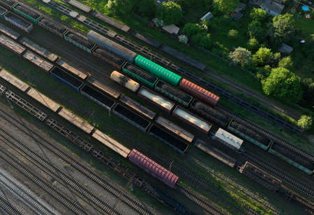 Railway yard with freight rail wagons. Cargo trains with goods on railroad. Freight train with...