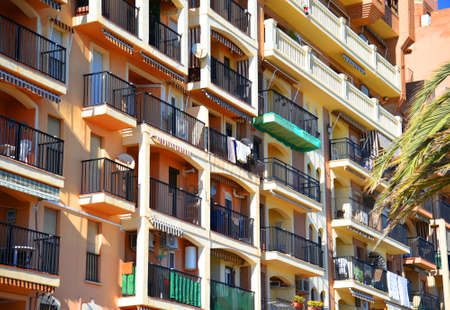 facade building. Residential building with balconies and windows. colorful apartment house. House with window and balcony. Buildings architecture and home facade. Modern minimalistic architecture.の写真素材