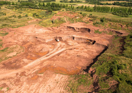 Clay mining in open pit. Aerial view of an opencast for the extraction of clay and limestone. Brick...