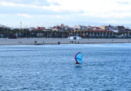 windsurfing sailing. Sailing sport. Surfer on board is surfing in the sea. Surfer catches a wave on...