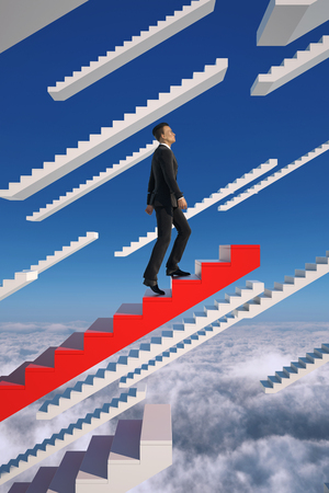 Go to success. Businessman climbs a red flying stairs.の写真素材